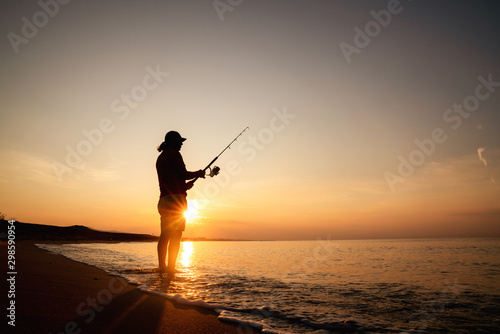 Fishing in the Sunrise on a sandy beach for healthy life