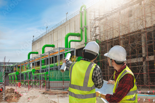 Professional civil engineer project cooling tower construction. Engineer foreman discussion pipeline work.