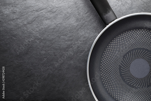 Black skillet with non-stick surface on slate background