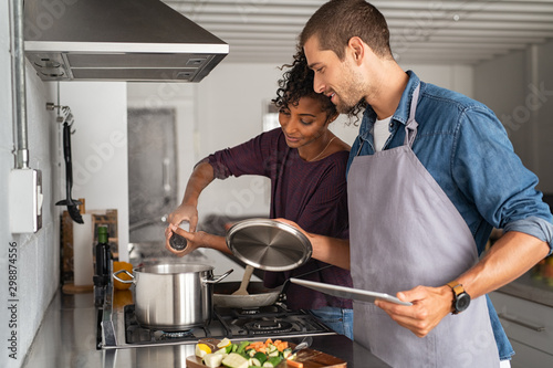 Woman adding salt in pot while cooking