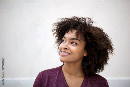 horizontal portrait of smiling young african american woman looking away