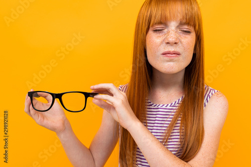 a teenager with myopia holds glasses for sight