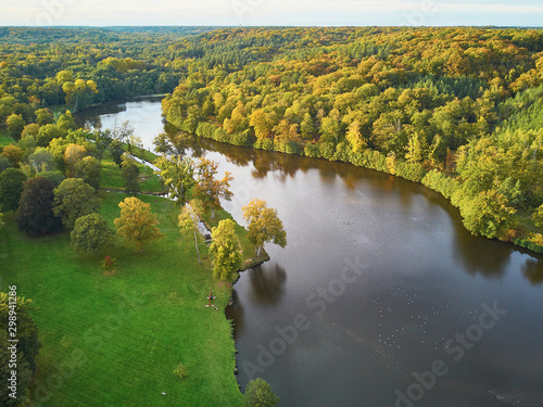 Scenic aerial view of a lake in autumn forest in northern France