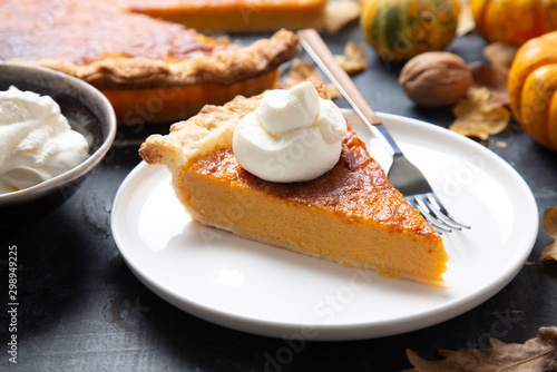 Portion of homemade thanksgiving pie with whipped cream