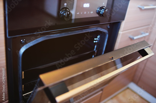 modern electric oven in kitchen interior with open door close up
