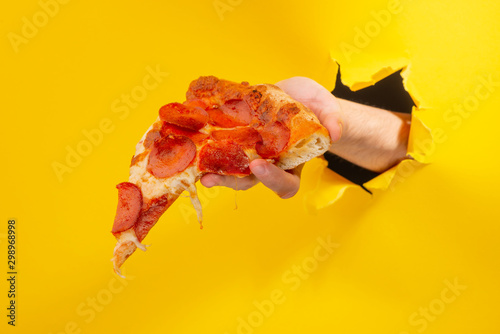 Hand giving a pizza slice