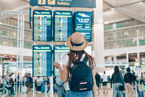 tourist at the airport looks at the scoreboard