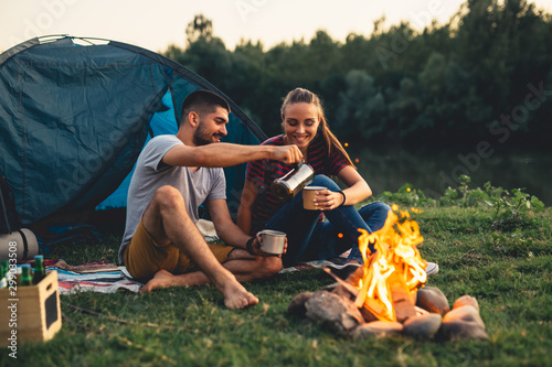 romantic couple on camping by the river outdoors