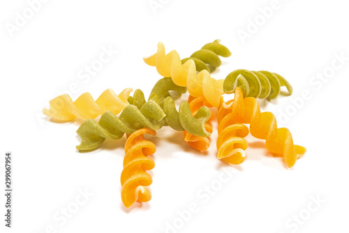 Fusilli tricolore raw dry pasta pile isolated on white