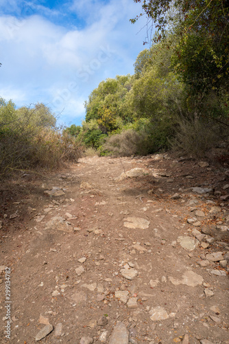 Road with stones and sand with slope in the natural park of Algeciras