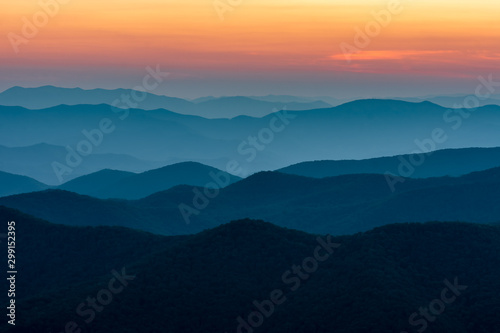 Scenic drive from Cowee Mountain Overlook on Blue Ridge Parkway at sunset time.