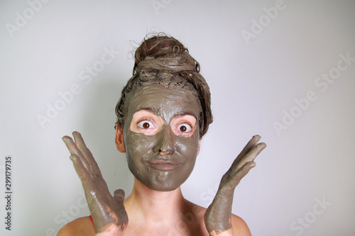 Young girl made a mask of dead sea mud for face and hair