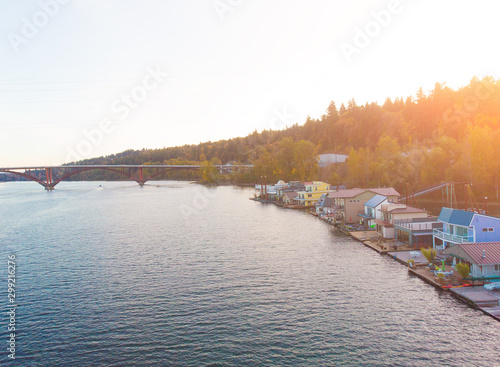 A pier with houses on the water in the USA at sunset in autumn, shot from above using a drone