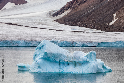 Iceberg next to the edge of a glacier in Ellesmere Island, part of the Qikiqtaaluk Region in the Canadian territory of Nunavut.