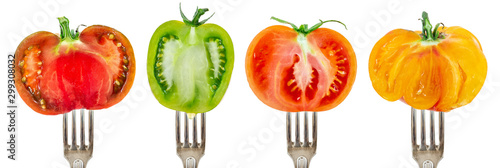 Collection of half tomatoes on forks aligned and isolated on white