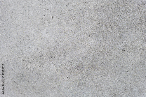 Gray textured cement wall background with fine concrete chips. Construction backgrounds