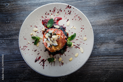 top view on delicious baked apple with syrop, nuts and mint