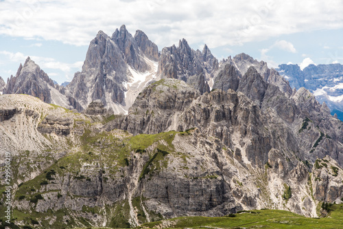 Dolomites, Italy - July, 2019: Drei Zinnen or Tre Cime di Lavaredo with beautiful flowering meadow, Sextener Dolomiten or Dolomiti di Sesto, South Tirol, Dolomiten mountains view, Italian Alps