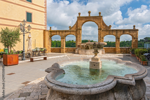 Ancient Fountain and arches in Repubblica square in Pitigliano, Italy.