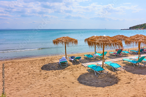 Beach with straw umbrellas by the sea