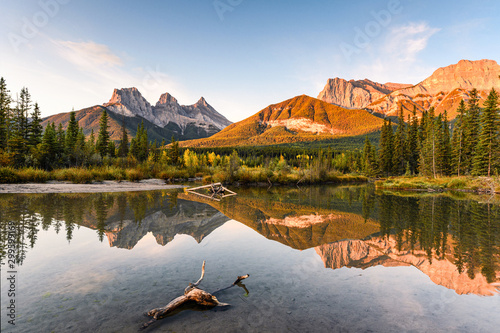 Scenery of Three sisters mountain reflection on pond at sunrise in autumn at Banff national park