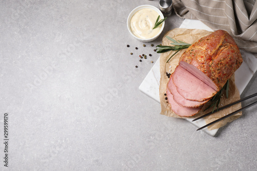 Delicious ham served on grey table, flat lay. Space for text