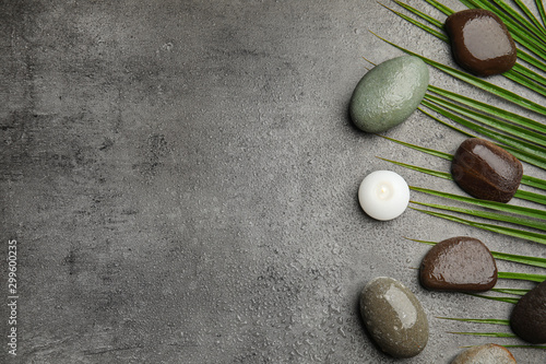 Flat lay composition with stones on grey background, space for text. Zen concept