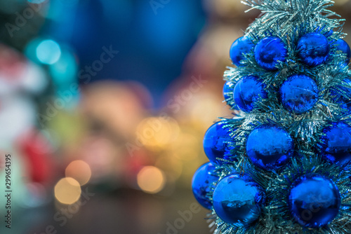 Close-up of blue christmas tree, and Christmas holiday background concept with toys, decorations, ornaments