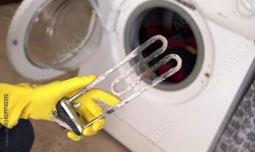 Treatment of Calcium Deposits in Water Heater. Limescale on the heating element for washing machine. Replacing a heating element