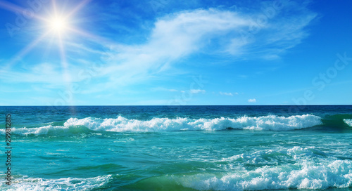 Sea and sun on blue sky background. Wide photo.