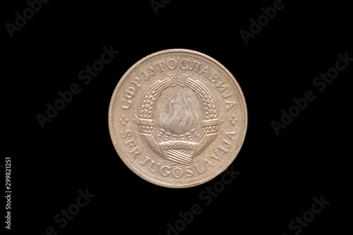 Socialist Federal Republic of Yugoslavia old 2 Dinara coin from 1980, obverse showing the state emblem of Yugoslavia. Isolated on black background