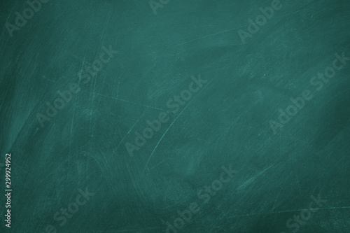 Texture of chalk on green blackboard / chalkboard background, can be use as concept for school education, dark wall backdrop , design template.