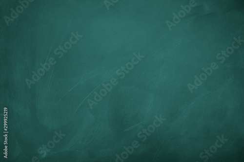 Texture of chalk on green blackboard / chalkboard background, can be use as concept for school education, dark wall backdrop , design template.