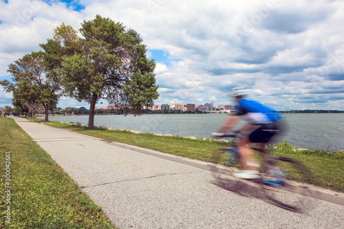Motion Blur of a person riding a bicycle past the capitol city of Wisconsin in Madison