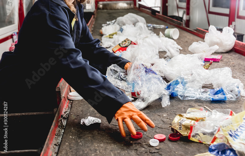 At modern recycling plant. Separate garbage collection. Workers sorting trash to be processed. Trash sorting.