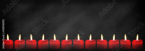 Red candles on panoramic blackboard background