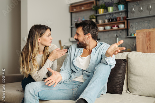 Frustrated young couple arguing at home