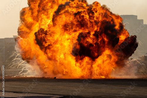 Massive fire explosion or strike in military combat and war. Vehicle explosion from a tank in a city in the Middle East. Military Concept. Strength, power, explosion.