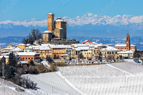 Small medieval town on snowy hill in Italy.
