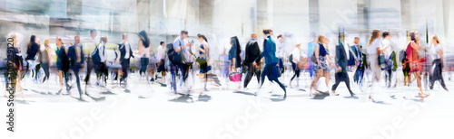 Walking people blur. Lots of people walking in the City of London. Wide panoramic view of people crossing the road. 