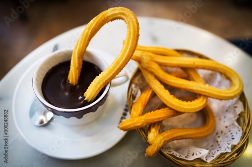 This image captures shows tradition and delicious fresh churros along side hot chocolate at a cafe in Spain