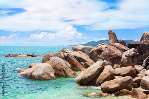 Hin Ta and Hin Yai rocks view close up, Grandmother and Grandfather stones on blue sea, sunny cloudy sky background, famous tourist natural landmark on Lamai beach, Koh Samui tropical island, Thailand