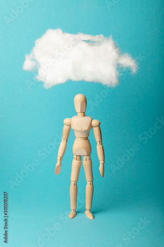Thoughts and reflections in form of cloud above head of wooden figure, dream concept.