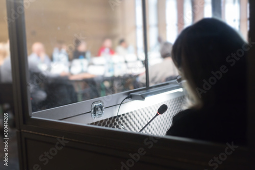 woman in translators cubicle