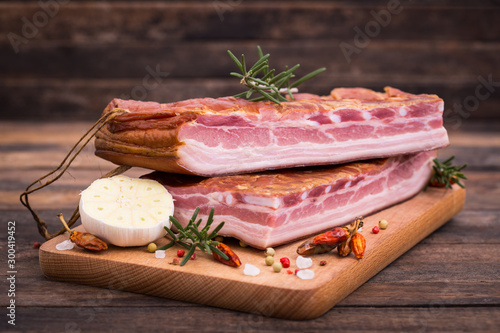 Homemade smoked bacon on wooden board