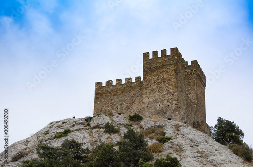 Tower of an old medieval fortress in the mountains.