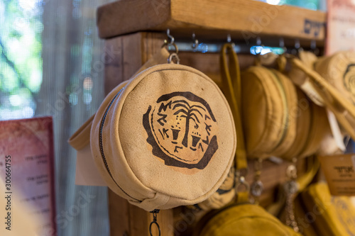 Leather decorative bag with the emblem of Ancient Shiloh in the store at the entrance to the Tel Shilo Archaeological Site in Samaria region in Benjamin district, Israel