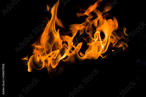 fire in a brazier closeup burning on a dark black background