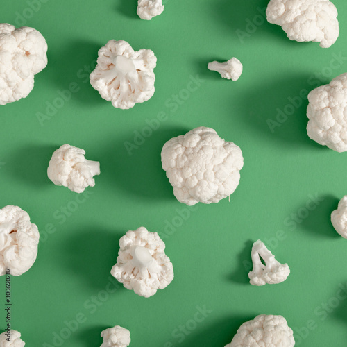 Cauliflower pattern. Piece of cauliflower on green background. Vegetables abstract background. Flat lay, top view, copy space