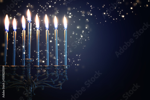 Religion image of jewish holiday Hanukkah background with menorah (traditional candelabra) and candles